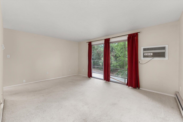 carpeted spare room featuring a baseboard radiator, a wall mounted air conditioner, and a textured ceiling