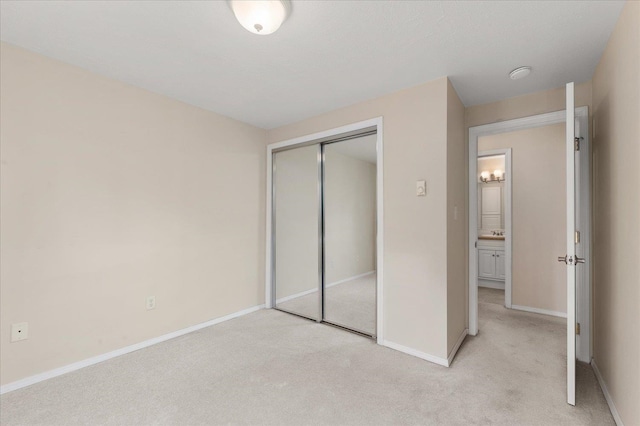 unfurnished bedroom featuring light colored carpet and a closet