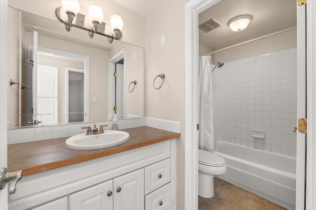 full bathroom featuring tile patterned floors, vanity, toilet, and shower / bath combo