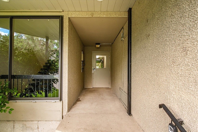 view of exterior entry with a balcony