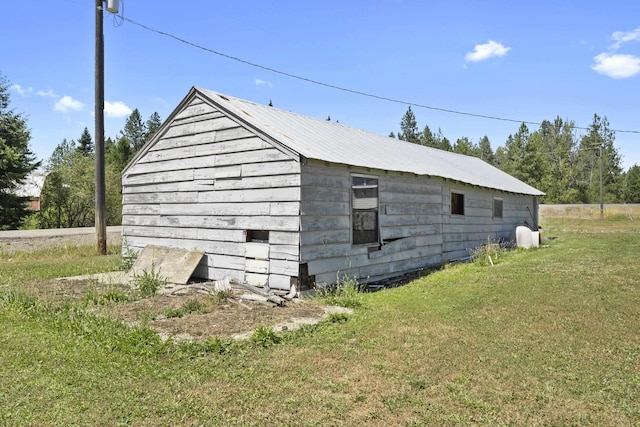 view of side of home featuring a yard