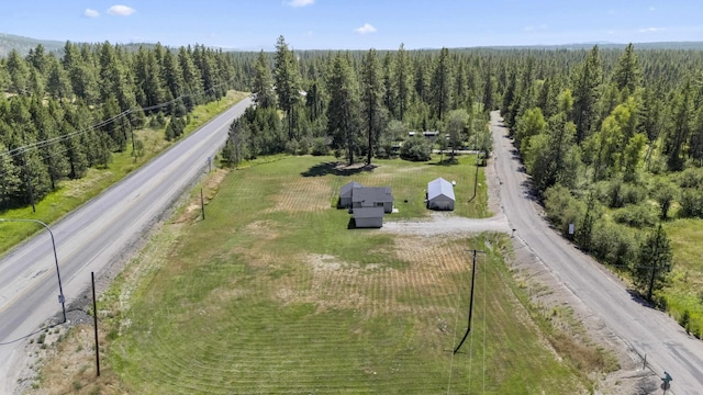 birds eye view of property featuring a wooded view