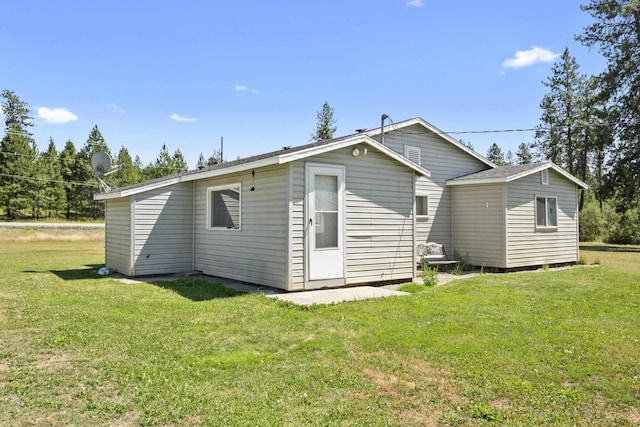 rear view of property with a yard