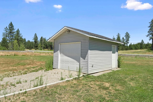 garage featuring a lawn