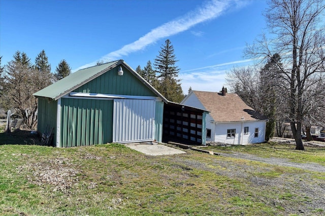 view of pole building featuring a garage and a yard