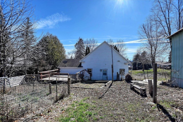 view of side of home featuring fence