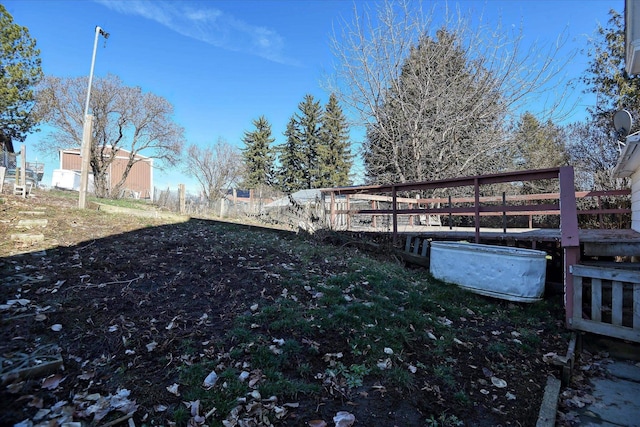 view of yard with an outdoor structure and fence