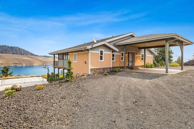 view of front of home with a water and mountain view