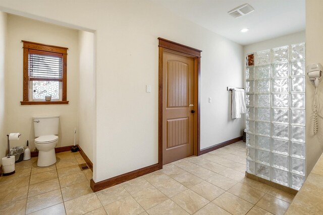 bathroom featuring toilet and tile patterned flooring