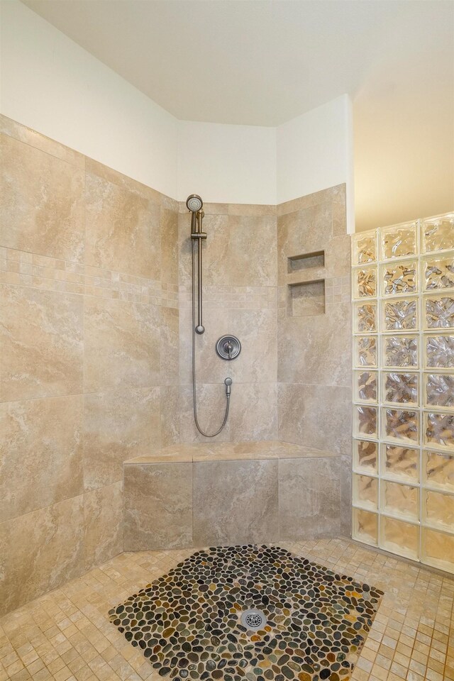 bathroom with tiled shower