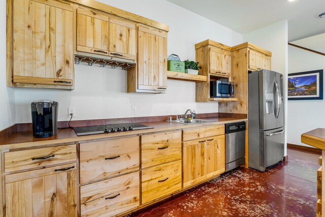 kitchen featuring light brown cabinetry, sink, and appliances with stainless steel finishes