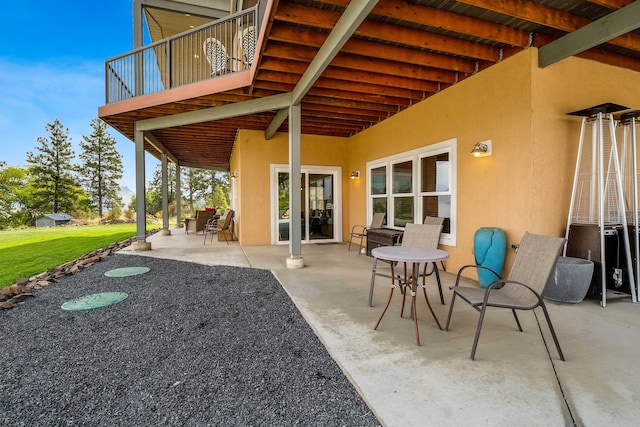 view of patio featuring a balcony