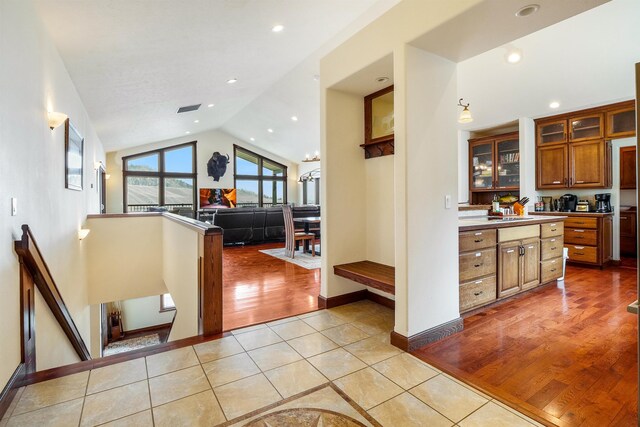 kitchen with lofted ceiling and light hardwood / wood-style flooring