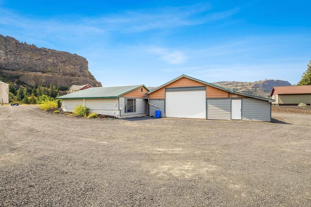 view of front of home featuring a mountain view, an outbuilding, and a garage