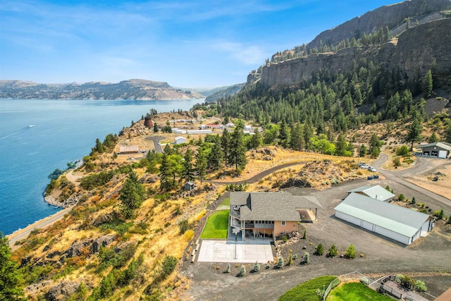 birds eye view of property featuring a water and mountain view