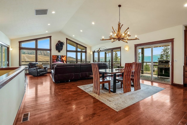 dining room with an inviting chandelier, dark hardwood / wood-style floors, and a healthy amount of sunlight