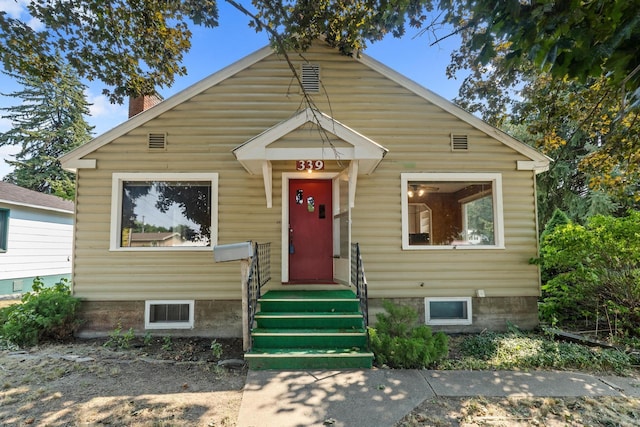 bungalow-style house with entry steps