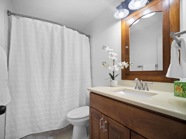 bathroom featuring tile patterned flooring, curtained shower, vanity, and toilet