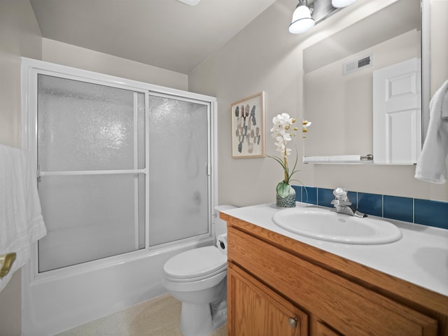 full bathroom featuring toilet, vanity, and enclosed tub / shower combo