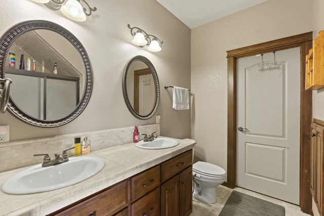 bathroom with tile patterned flooring, toilet, decorative backsplash, and vanity