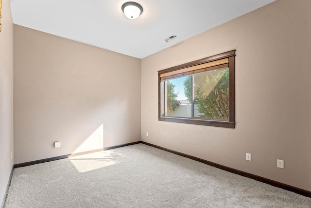 unfurnished room featuring light colored carpet