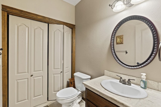 bathroom featuring toilet and vanity