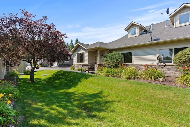 rear view of property with a lawn