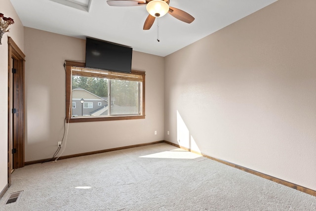 empty room with light colored carpet and ceiling fan