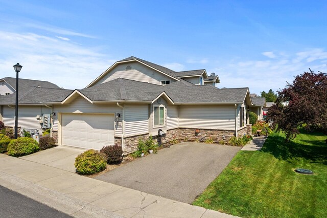 view of front of property with a front lawn and a garage