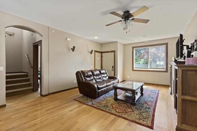 living room featuring ceiling fan and light hardwood / wood-style floors