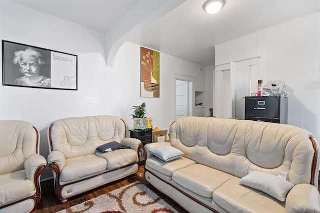 living room with beam ceiling and hardwood / wood-style flooring