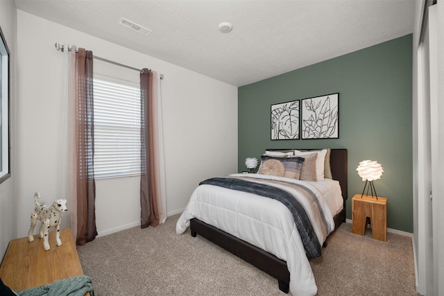 carpeted bedroom with a textured ceiling