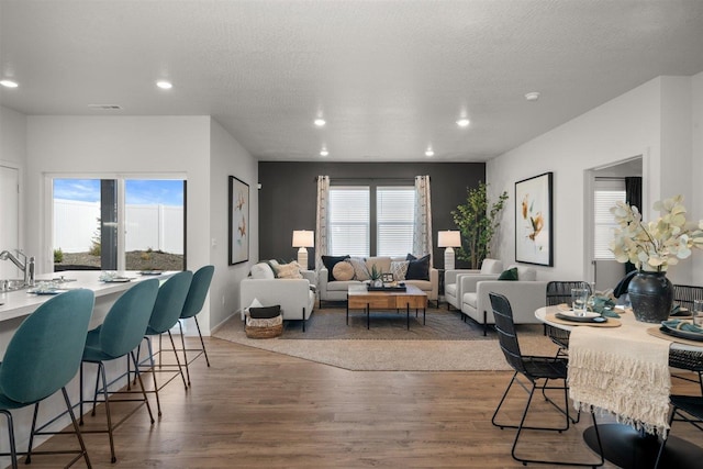 interior space featuring a textured ceiling, wood-type flooring, and a wealth of natural light