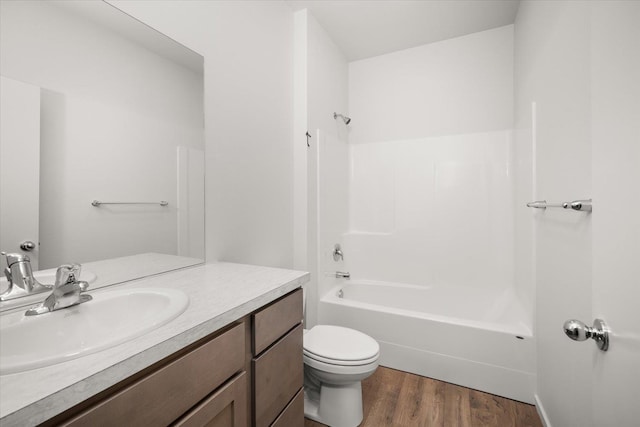 full bathroom with tub / shower combination, vanity, toilet, and hardwood / wood-style floors