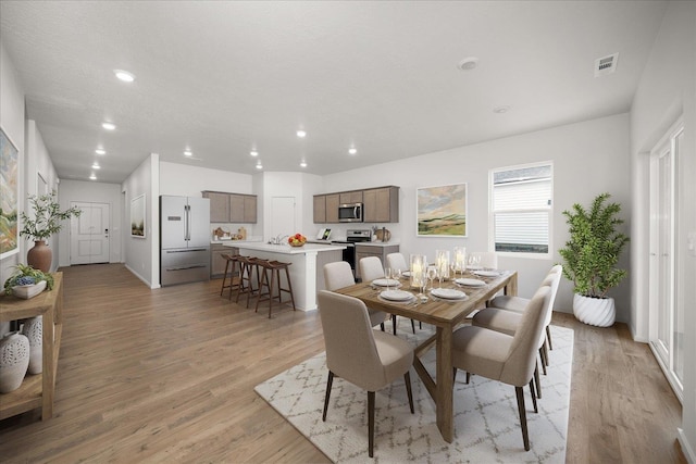 dining space with light hardwood / wood-style floors