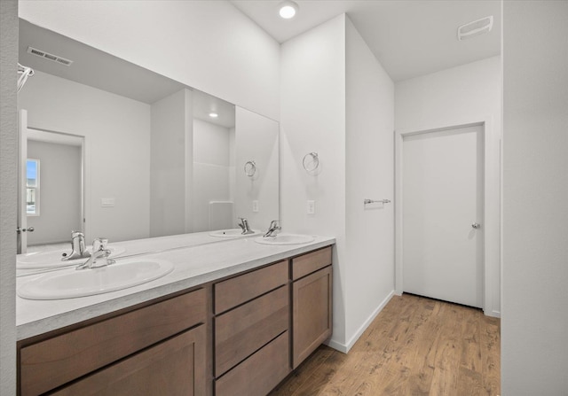 bathroom featuring double sink vanity and hardwood / wood-style flooring