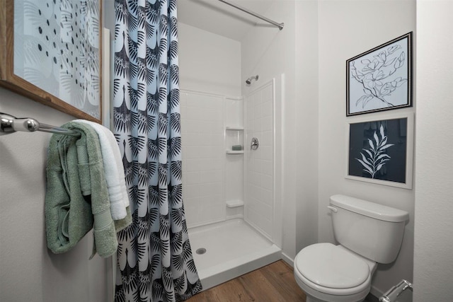 bathroom with a shower with shower curtain, toilet, and hardwood / wood-style flooring