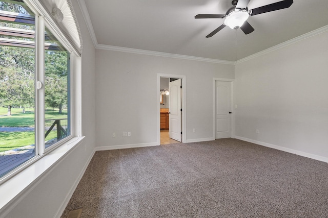 unfurnished bedroom featuring visible vents, crown molding, baseboards, carpet flooring, and ensuite bathroom