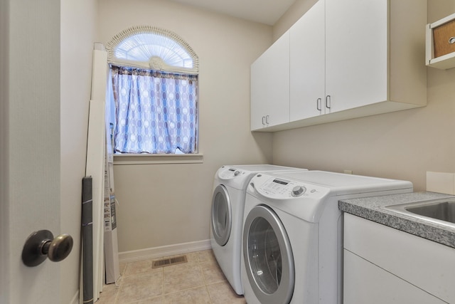 washroom with visible vents, cabinet space, separate washer and dryer, and plenty of natural light