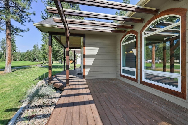 wooden terrace featuring a lawn