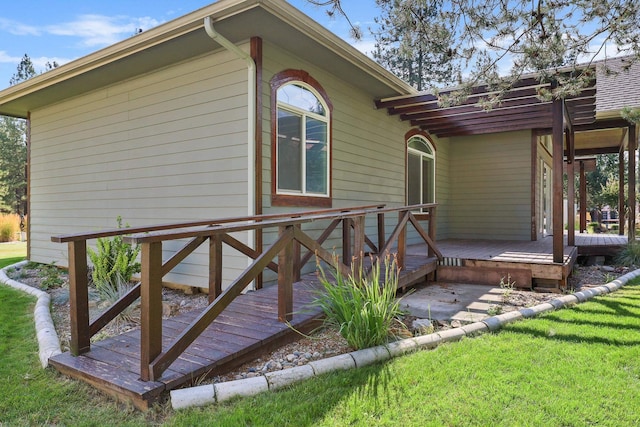 rear view of property with a yard and a wooden deck