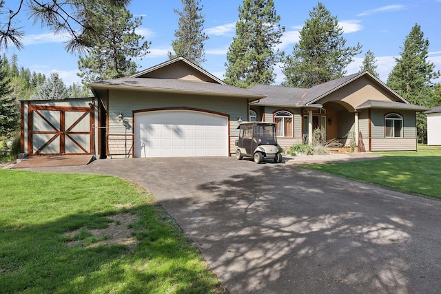 ranch-style home with driveway, a front lawn, and a garage