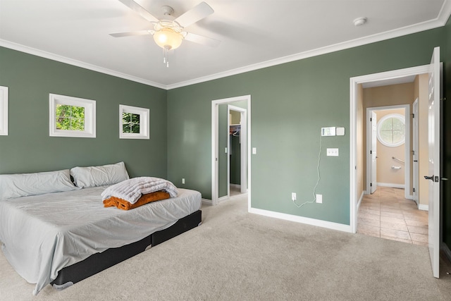 bedroom featuring light carpet, light tile patterned floors, baseboards, and crown molding