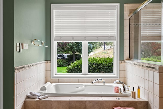 full bath featuring a stall shower and a bath