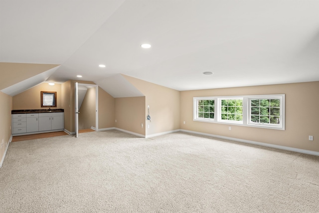 bonus room featuring recessed lighting, light carpet, vaulted ceiling, and baseboards