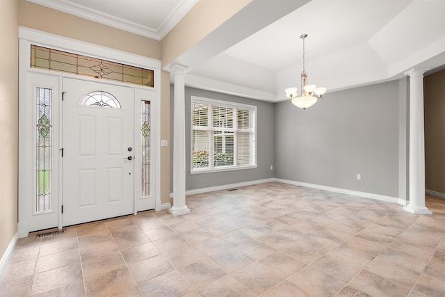 foyer entrance featuring ornate columns, baseboards, and ornamental molding