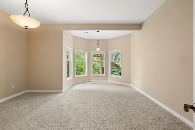 empty room with carpet flooring and baseboards