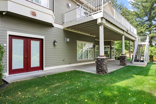 property entrance featuring a patio area, a yard, and french doors