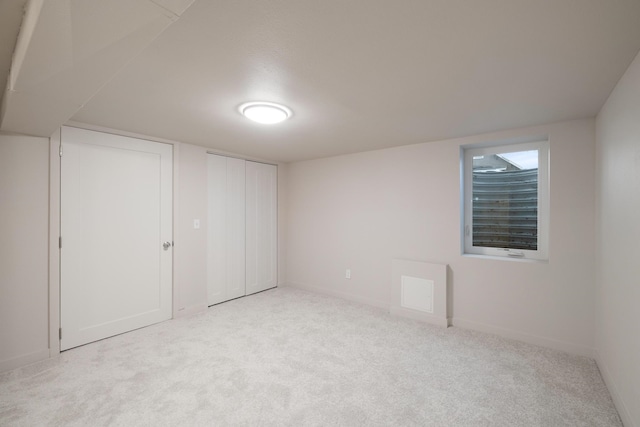 interior space with light colored carpet and two closets