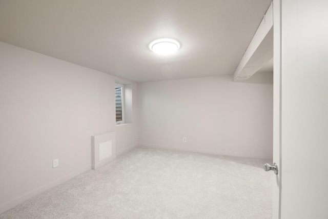 spare room featuring light carpet